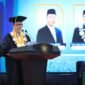 Rektor USK Prof. Mirza Tabrani, S.E., M.B.A., D.B.A., menyampaikan orasi ilmiah pada peringatan Milad ke-65 USK di Gedung AAC Dayan Dawood, Banda Aceh, Senin (12/10/2026). Foto: (Humas USK)